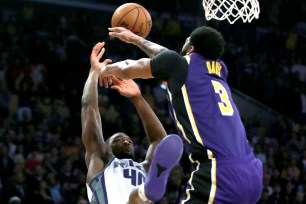 Anthony Davis blocks Harrison Barnes' shot at the buzzer to securd the Lakers' 99-97 win Friday night.