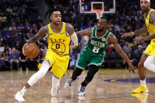 D'Angelo Russell, who left the game with a sprained thumb, drives to the basket during the Warriors' 105-100 loss to the Celtics on Friday night.