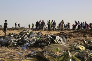 Rescuers work at the crash site of Ethiopian Airlines plane.