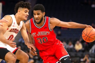 LJ Figueroa drives on Josh Green during St. John's 70-67 upset win over Arizona on Saturday night.