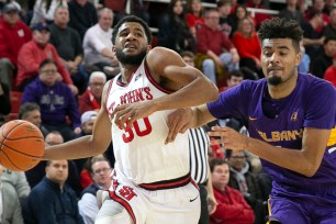 LJ Figueroa drives to the basket as St. John's defeats Albany, 85-57, on Dec. 18.