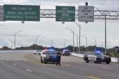 Police vehicles block the entrance to the Pensacola Air Base.