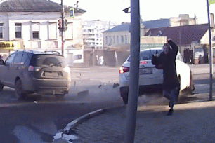 Two colliding cars skid just inches away from terrified pedestrians