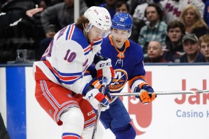 Derick Brassard, who was called for a penalty in the game's final minute, battles Artemi Panarin for the puck earlier in the Rangers' 3-2 win over the Islanders on Thursday night.