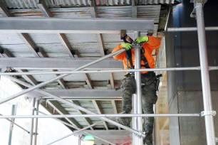 Worker putting up scaffolding