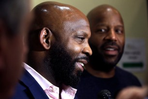 Entrepreneurs Kevin Hart, of Randolph, Mass., left, and Kobie Evans, of Boston, right, speak to reporters after attending a meeting of the Massachusetts Cannabis Control Commission.