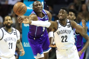 Caris LeVert battles Bismark Biyombo for a loose ball during the Nets' 115-86 win over the Hornets.