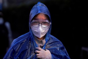 A passenger wearing a mask walks at the Shanghai railway station in China, as the country is hit by an outbreak of the novel coronavirus.