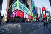 A billboard warns about close contact and empty streets in Times Square on March 25, 2020. Stephen Yang