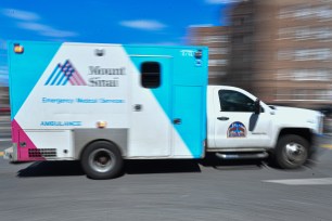 A Mount Sinai ambulance drives through Kings Highway in Brooklyn.