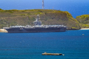 The USS Theodore Roosevelt, a Nimitz-class nuclear powered aircraft carrier, is docked along Kilo Wharf of Naval Base Guam in Sumay.