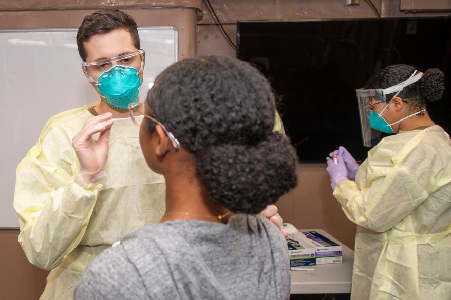 US Navy medical staff taking a swab sample for COVID-19 testing aboard the aircraft carrier USS Theodore Roosevelt