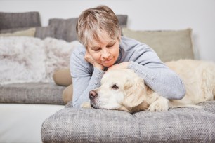 Senior woman pets her dog