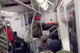 Masked NYC subway rider caught on camera slugging straphanger