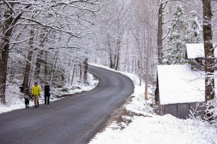 Peter and Joanna Brown walk their dog in West Paris, Maine today.