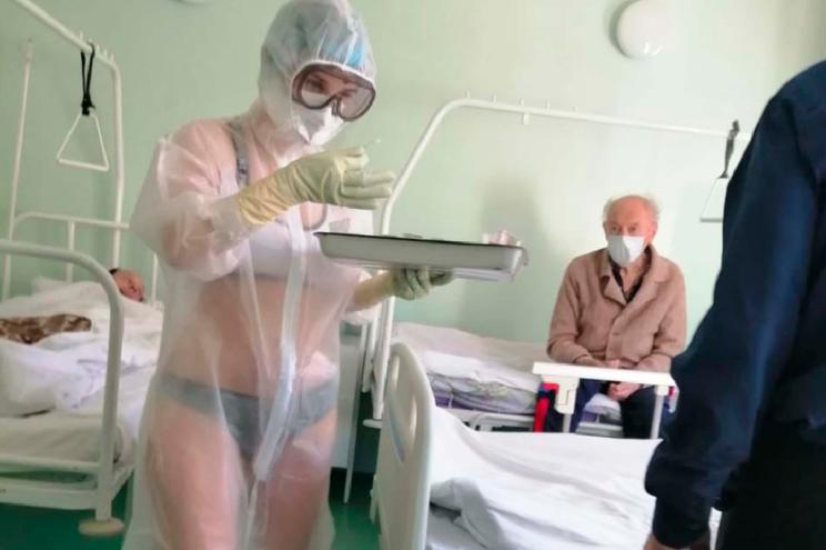 a nurse with only underwear beneath her clear hospital gown