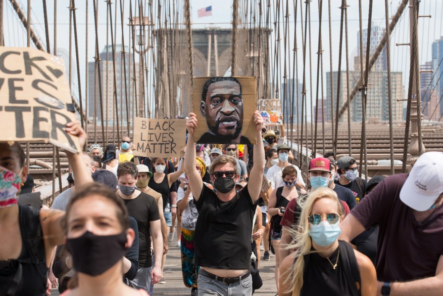 Marchers protesting police brutality march across the Brooklyn Bridge into Manhattan on June 6, 2020.