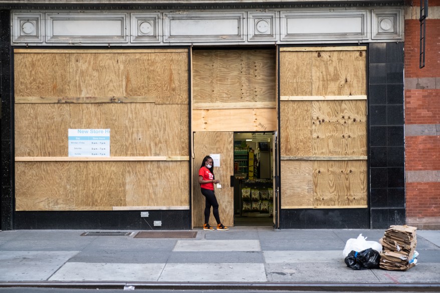 Storefronts in Manhattan with plywood set up to prevent looting opened up this past week after months of closures due to the COVID-19 pandemic.