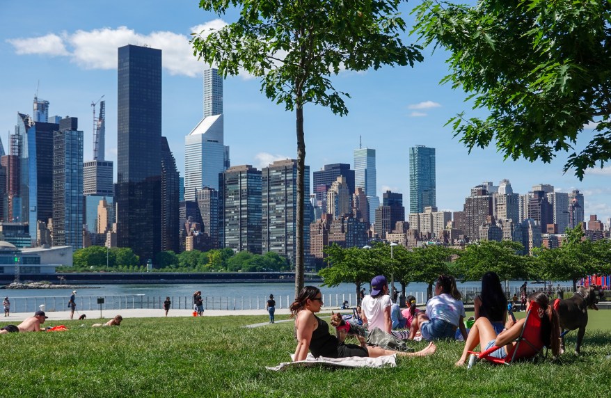 People enjoy the green space overlooking midtown Manhattan over the East river from Long Island City on June 8, 2020.