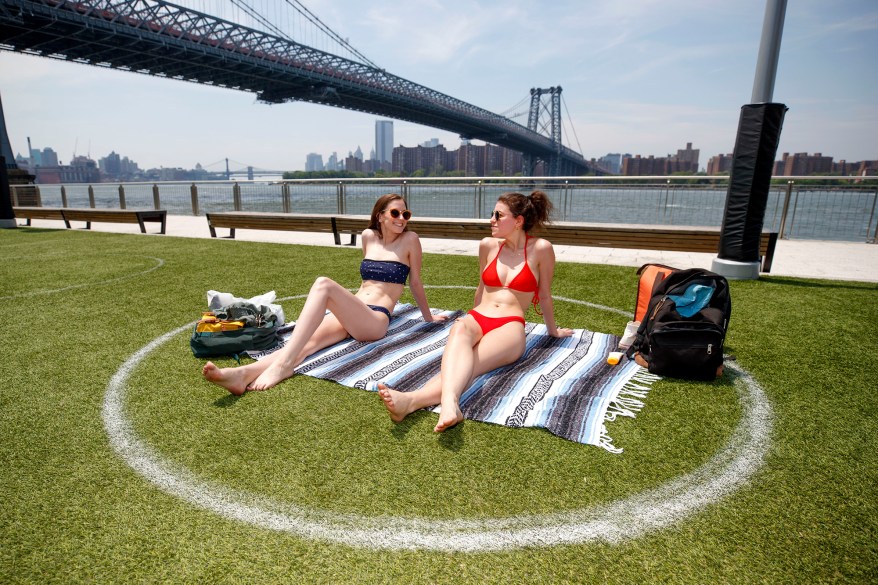 Jennifer, right, from Brooklyn and her friend Noelle , left, visiting from Philadelphia get some sun at Domino Park in Brooklyn on June 10, 2020.