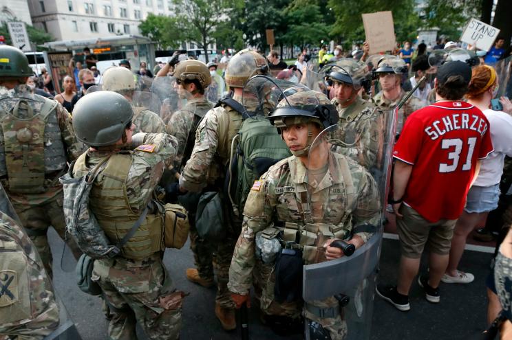 Members of the South Carolina National Guard arrive and walk through demonstrators protesting the death of George Floyd in Washington.