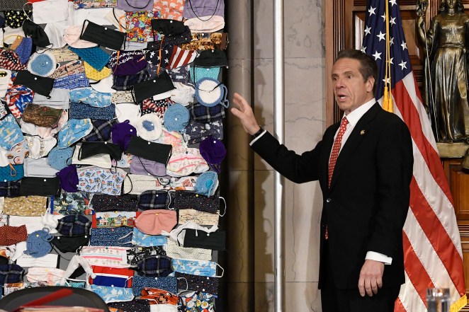 Gov. Andrew Cuomo unveiling a display of face masks at an April 29 news conference.