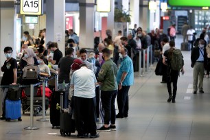 Travelers line up to board a flight at Berlin's Tegel Airport on Monday.