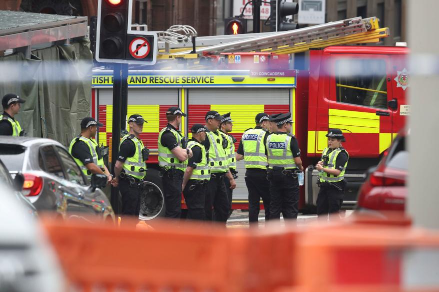 Emergency responders near the scene of a stabbing in Glasgow, Scotland.