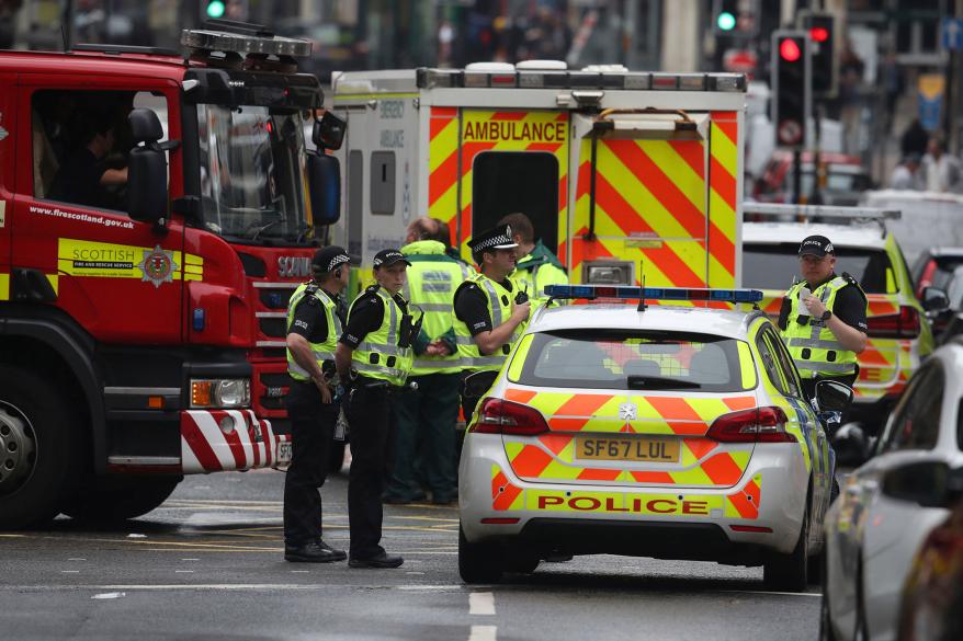 Emergency responders near the scene of a stabbing in Glasgow, Scotland.