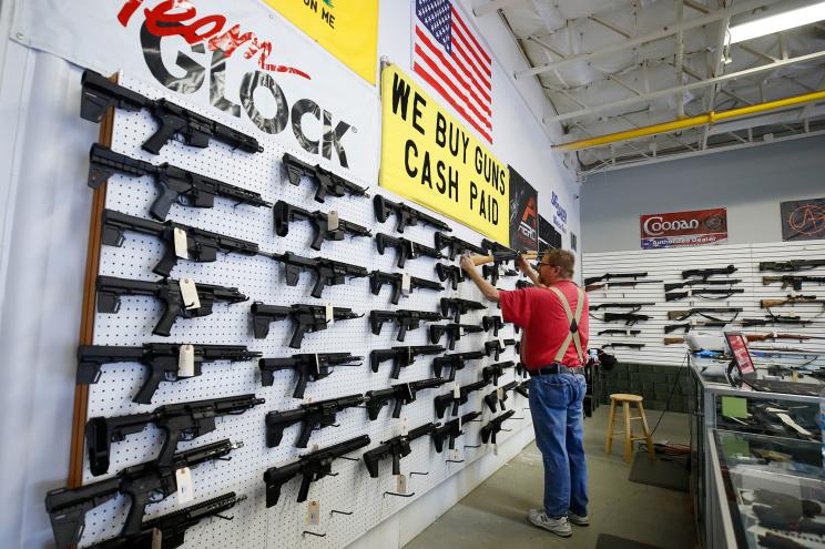 A worker restocks AR-15 guns at Davidson Defense in Orem, Utah, in March.