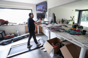 Belgian Yves Hanoulle, IT professional, walks on a treadmill installed under his desk as he works in his home in Ghent, Belgium.