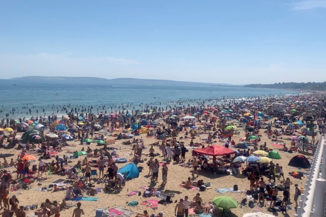 People enjoy the hot weather at the beach, amid the outbreak of the coronavirus, in Bournemouth, Britain.