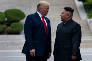 Donald Trump and Kim Jong-un stand on North Korean soil while walking to South Korea in the Demilitarized Zone.