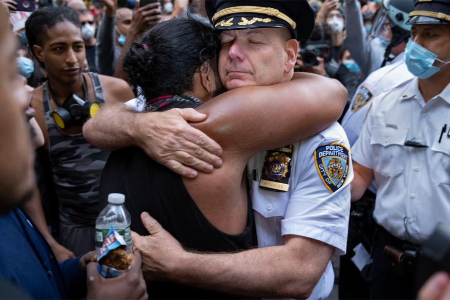 Chief of Department of the New York City Police, Terence Monahan hugs a protester on June 1.