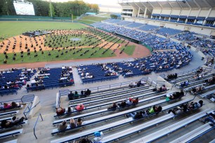 Seniors at Spain Park High School sit on a baseball field during a socially distanced graduation ceremony in Hoover, Alabama.