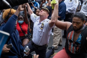 Chief of Department of the New York City Police, Terence Monahan takes a knee with protesters on June 1.