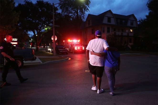 Two people walk away from West Suburban Medical Center in Oak Park, in Chicago, where a 3-year-old boy died after being shot while riding in an SUV with his father a few blocks away in the Austin neighborhood