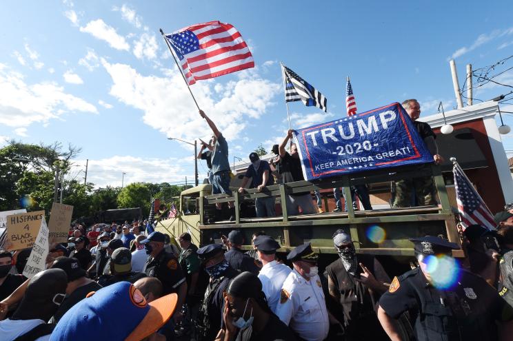 Supporters of President Donald Trump rally while protesters gather to march against racism and police brutality in Smithtown, New York.