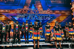 Members of the Ndlovu Youth Choir stand on stage during a taping of the U.S. television show America Got Talent in Los Angeles.