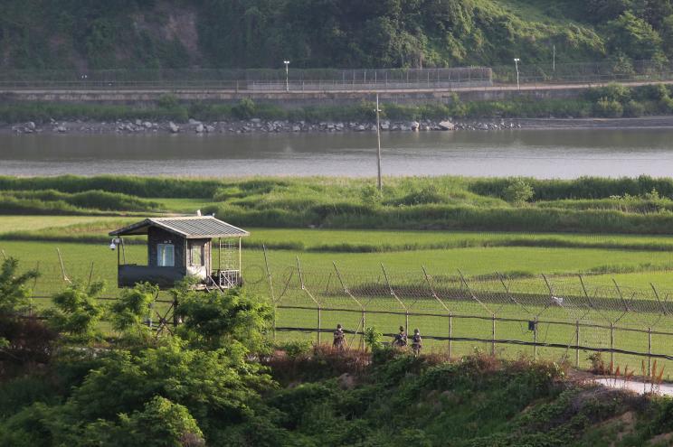 South Korean army soldiers patrol along the barbed-wire fence in Paju, South Korea, near the border with North Korea