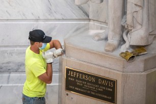 A worker prepares to remove the Jefferson Davis statue from the Kentucky state Capitol in Frankfort, Ky., on Friday, June 12, 2020.