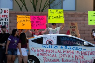 Arizona protestors demonstrate outside the home of Tucson's Mayor Regina Romero in opposition to the new mask mandate to prevent the spread of the coronavirus.