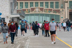 People walk on the boardwalk in Asbury Park, New Jersey.