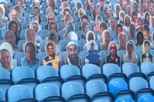 An Osama bin Laden cutout appears in the stands with other cutouts of fans.