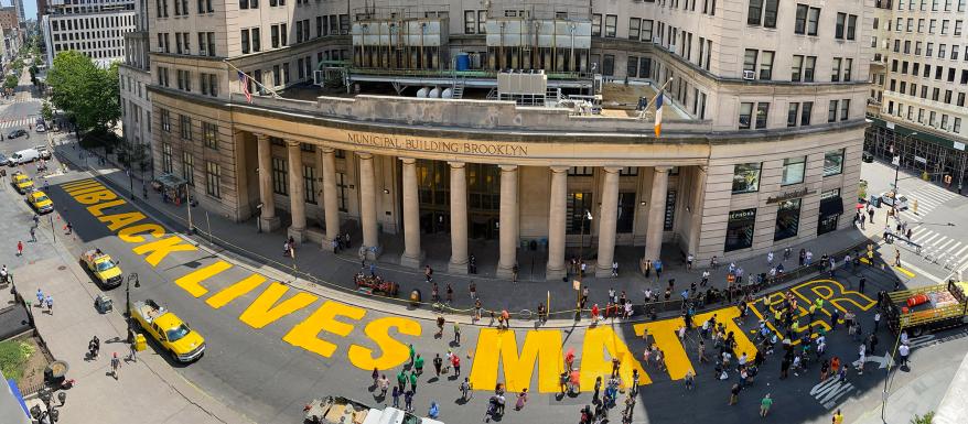 An aerial view of the Black Lives Matter street painting happening outside Brooklyn's Borough Hall