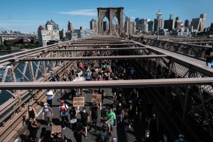 Protestors walk across the Brooklyn Bridge during a Black Lives Matter / Juneteenth march on June 19, 2020.