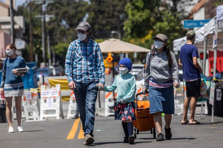 A family wearing face masks in Santa Monica, California.