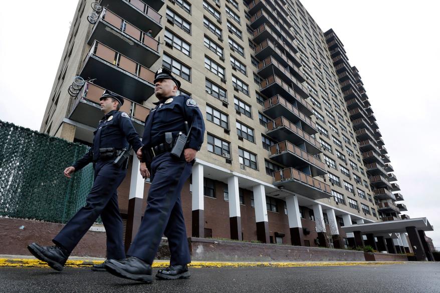 Camden County Metro police officers Lucas Murray (left) and Daniel Torres (right) patrol outside the high-rise apartment building, Northgate I, in Camden, New Jersey.