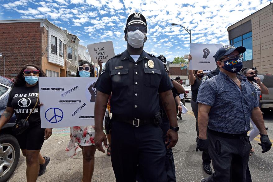 Lt. Zack James of the Camden County Metro Police Department marches along with demonstrators in Camden, New Jersey.