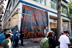 A sign which reads "this is property of the Seattle people" is pictured on the closed Seattle Police Department's East Precinct.